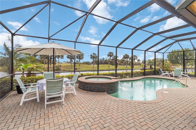 view of swimming pool with glass enclosure, a patio area, and a pool with connected hot tub