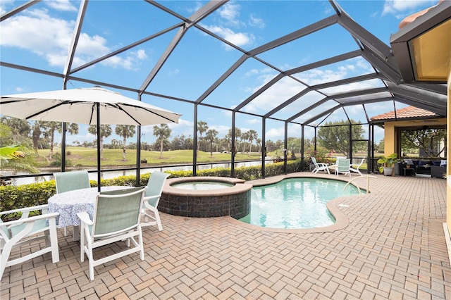 view of swimming pool with glass enclosure, a patio area, and a pool with connected hot tub