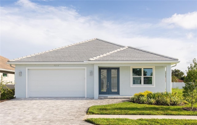 view of front of property with a garage and french doors