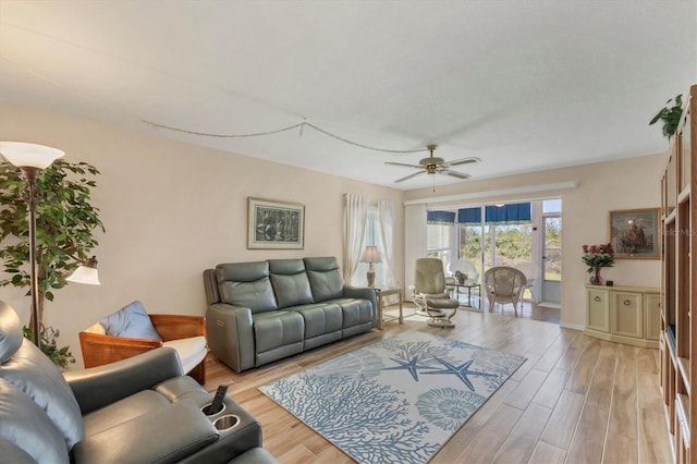 living room featuring light wood-style flooring and ceiling fan