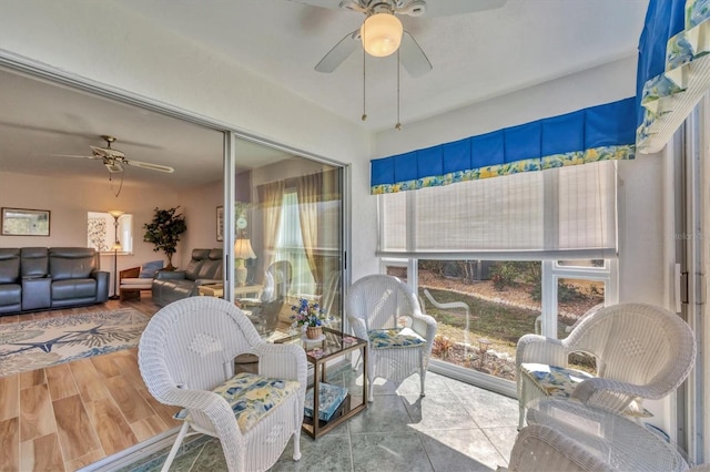 sunroom featuring a ceiling fan