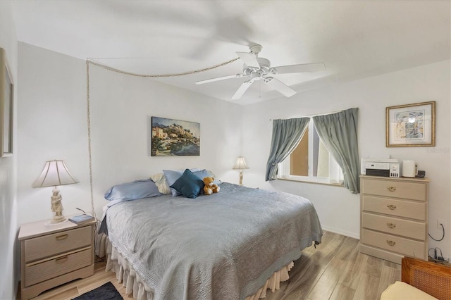 bedroom with ceiling fan and light wood-type flooring