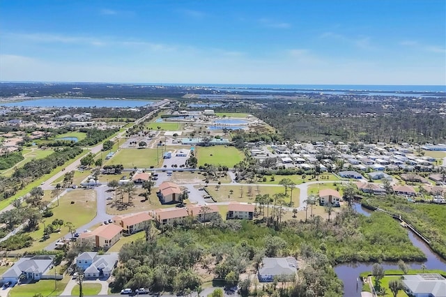 drone / aerial view featuring a residential view and a water view