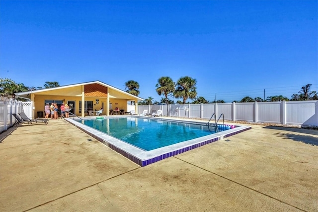 pool with fence and a patio