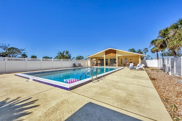 pool with a patio and a fenced backyard