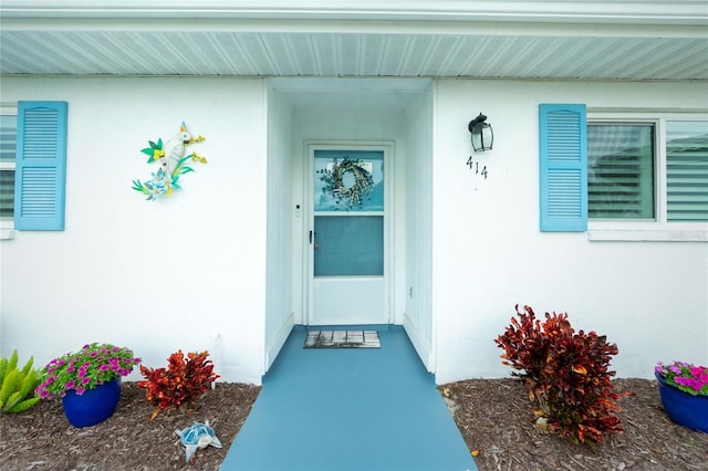 entrance to property with stucco siding