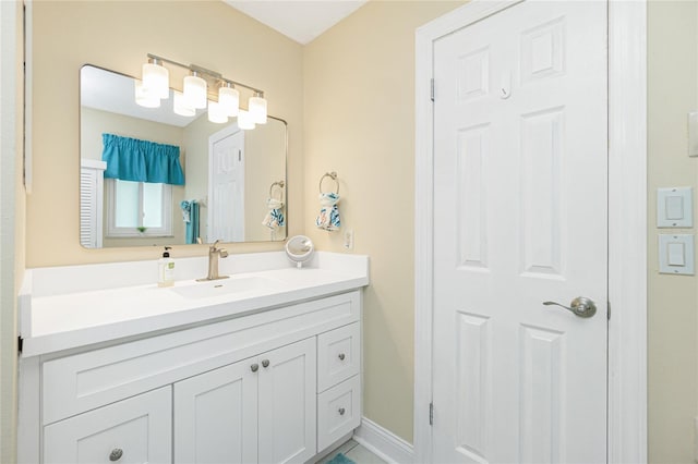 bathroom with baseboards and vanity