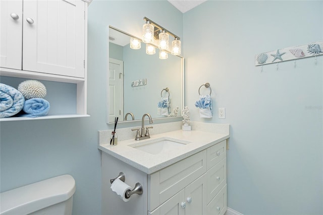 bathroom with toilet and vanity