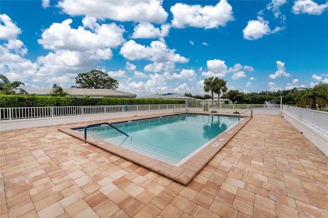 pool featuring a patio area and fence