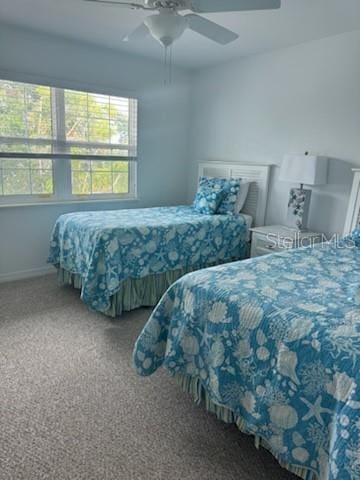 carpeted bedroom with a ceiling fan and baseboards