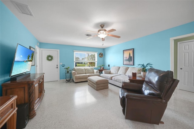 living area with ceiling fan, light speckled floor, and visible vents