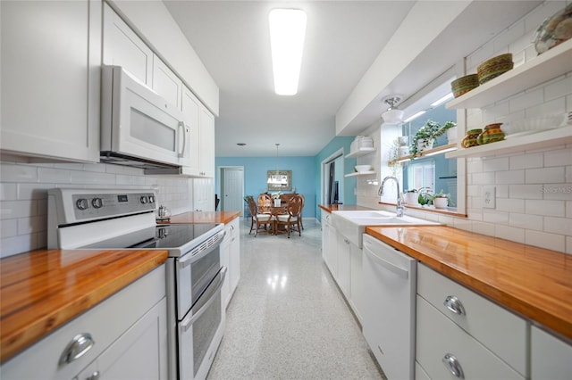 kitchen with white cabinetry, butcher block counters, white appliances, and open shelves