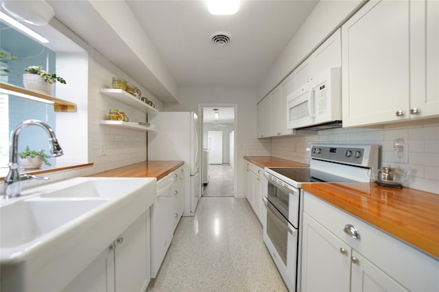 kitchen featuring a sink, white appliances, butcher block counters, and white cabinetry