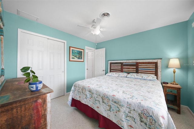 bedroom featuring a ceiling fan, a closet, visible vents, and light colored carpet