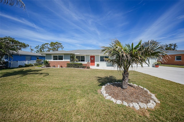 ranch-style house featuring a garage, driveway, and a front lawn