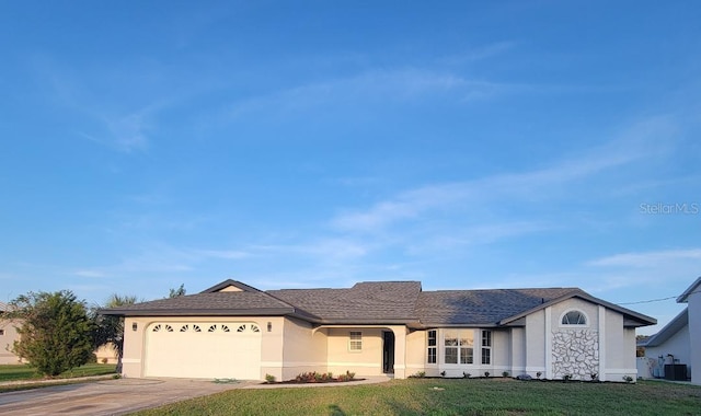 ranch-style home with central AC unit, concrete driveway, an attached garage, a front yard, and stucco siding