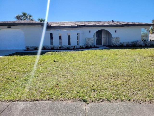 view of front of house featuring stucco siding, driveway, an attached garage, and a front lawn