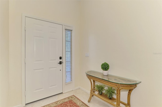 entrance foyer with light tile patterned floors and baseboards