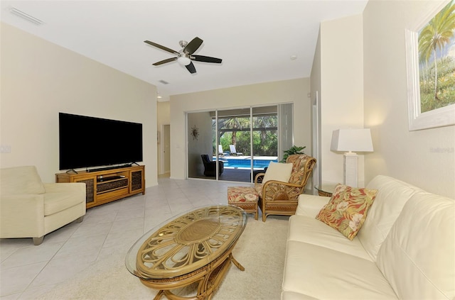 living area with ceiling fan, visible vents, and light tile patterned flooring