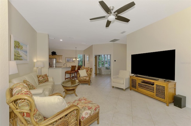 living area featuring visible vents, a ceiling fan, and light tile patterned flooring