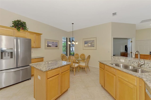 kitchen with stainless steel fridge, a sink, visible vents, and light tile patterned floors