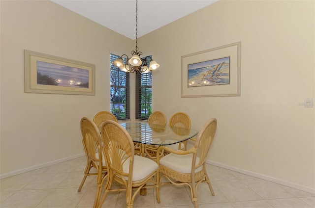 dining area featuring light tile patterned floors, baseboards, and an inviting chandelier