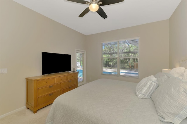 bedroom with light carpet, ceiling fan, and baseboards