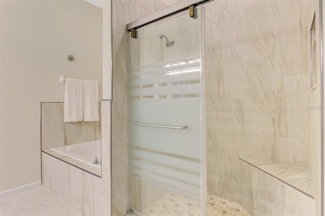 full bath with a stall shower, tile patterned flooring, and a garden tub