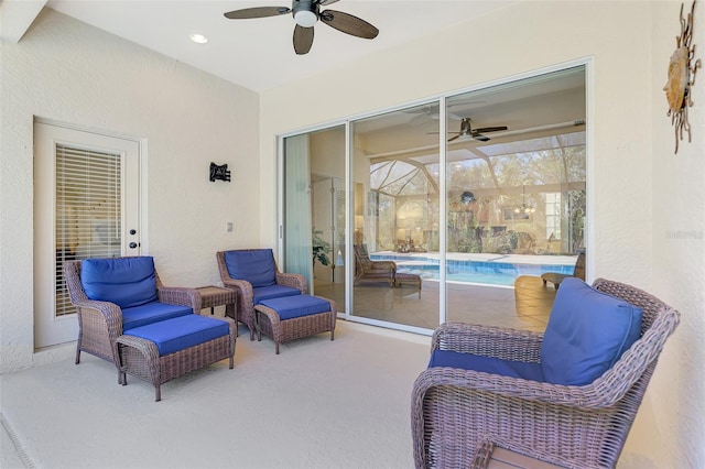 view of patio with an outdoor pool and a ceiling fan