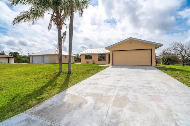 view of front of house with a front yard and concrete driveway