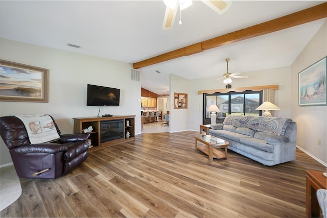 living room with vaulted ceiling with beams, visible vents, ceiling fan, wood finished floors, and baseboards