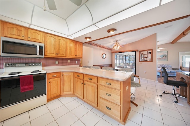 kitchen featuring open floor plan, light countertops, stainless steel microwave, and white electric range oven