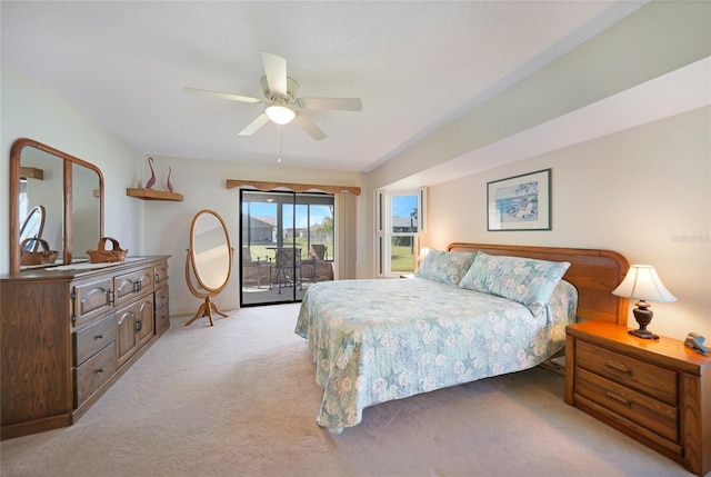 bedroom featuring a ceiling fan, light colored carpet, and access to exterior