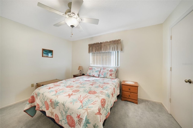 bedroom featuring ceiling fan, baseboards, and light colored carpet