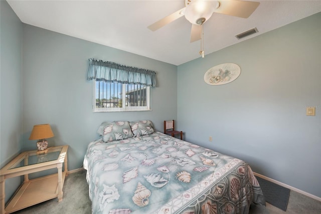 carpeted bedroom featuring a ceiling fan, visible vents, and baseboards