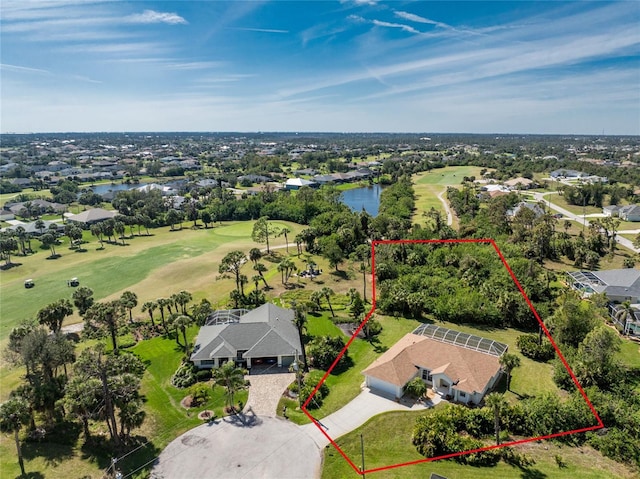 drone / aerial view with a residential view, a water view, and golf course view