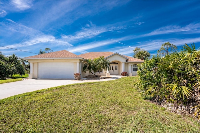 mediterranean / spanish home featuring a garage, concrete driveway, a front yard, and stucco siding