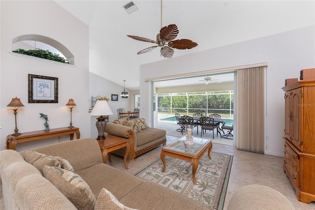 living area featuring lofted ceiling, a sunroom, visible vents, and a ceiling fan