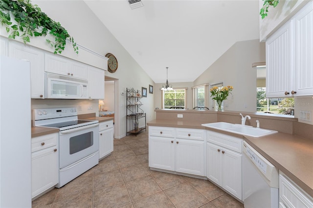 kitchen featuring white appliances, a sink, white cabinetry, light countertops, and decorative light fixtures