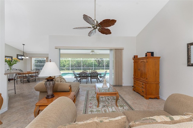 living room with light tile patterned floors, high vaulted ceiling, a sunroom, baseboards, and a ceiling fan