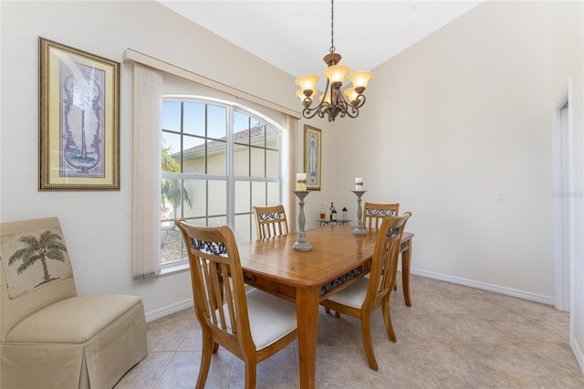 dining space featuring light tile patterned floors, vaulted ceiling, baseboards, and a chandelier