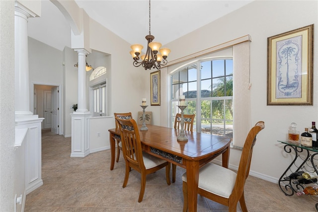 dining area featuring arched walkways, a notable chandelier, vaulted ceiling, and ornate columns