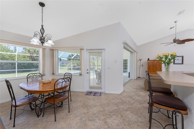 dining space with vaulted ceiling, ceiling fan with notable chandelier, visible vents, and baseboards