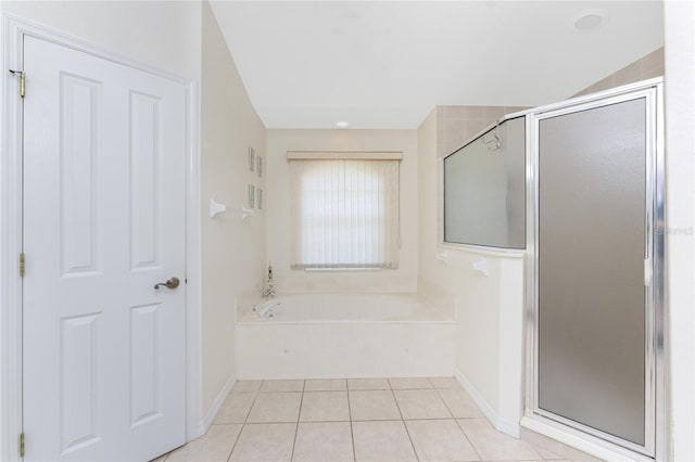 bathroom featuring a shower stall, a bath, and tile patterned floors