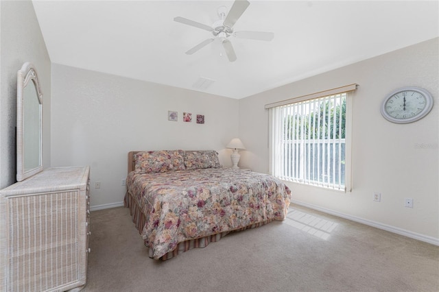 bedroom with light carpet, visible vents, a ceiling fan, and baseboards