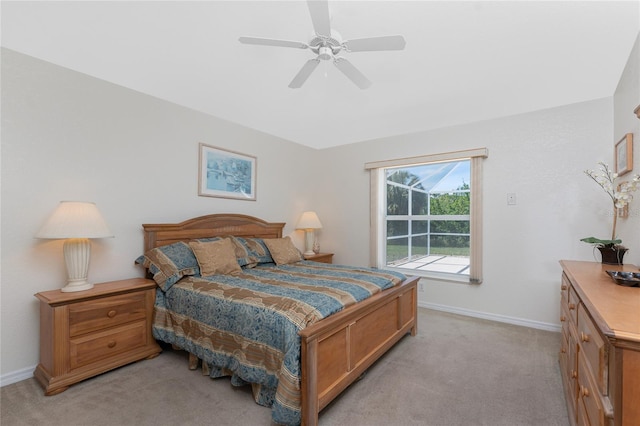 bedroom featuring baseboards, a ceiling fan, and light colored carpet