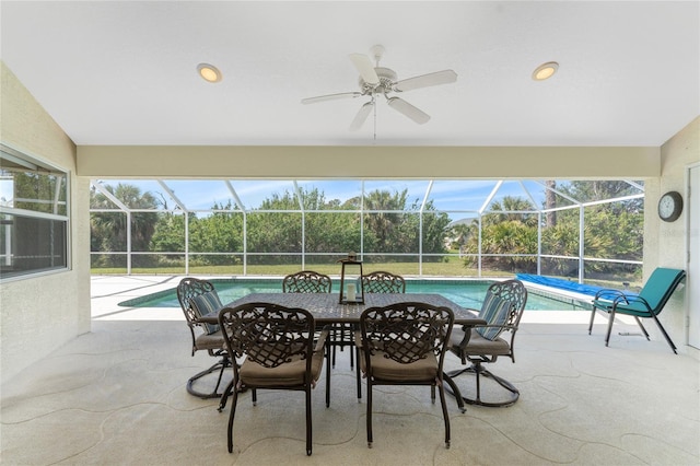 exterior space with a lanai, ceiling fan, and an outdoor pool