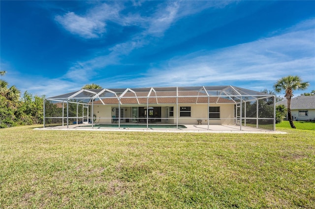 back of house featuring glass enclosure, a yard, and a patio