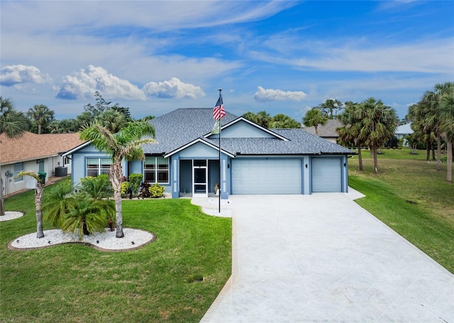 single story home featuring driveway, a front lawn, an attached garage, and a shingled roof