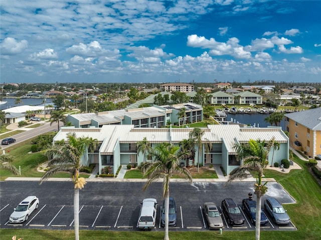 drone / aerial view featuring a water view and a residential view